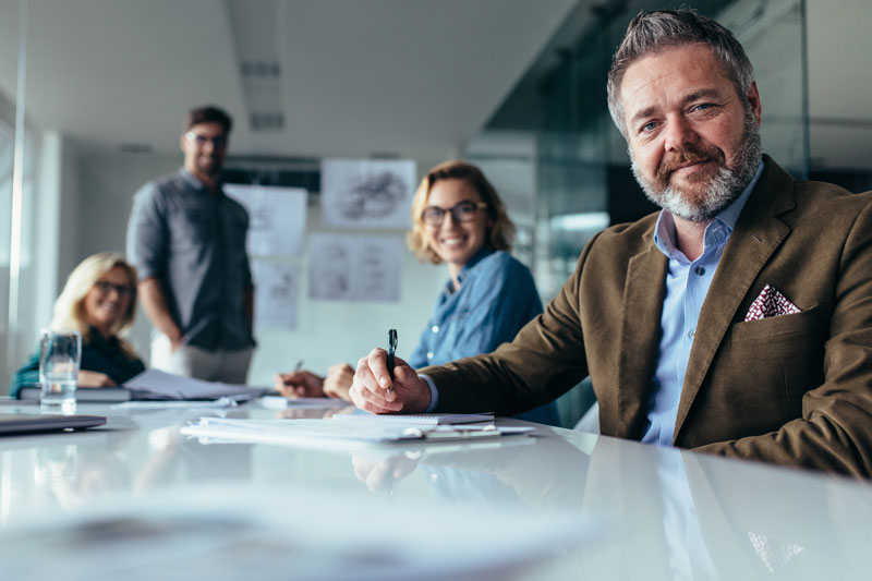 Group gathered around a conference table engaged in OFP Consulting